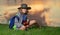 Cute blond kid with binoculars wearing explorer hat and backpack on nature. Child explorer hiking and adventure.