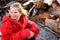 Cute Blond sitting on Wood Pile