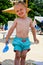 Cute blond smiling child at the beach