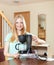 Cute blond unpacking and reading manual for new coffeemaker at h