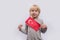 Cute blonde boy holds Turkish flag on white background. Children`s education in Turkey