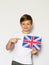 Cute blonde boy posing with british flag