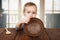 Cute blonde boy shows empty plate, hunger concept