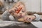 Cute blonde child helps to cook cookies. Little girl makes a gingerbread man from dough