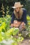 Cute blonde gardening on sunny day