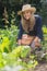 Cute blonde gardening on sunny day