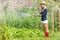 Cute blonde gardening on sunny day