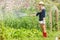 Cute blonde gardening on sunny day