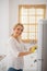 Cute blonde housewife cleaning the fridge