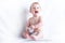 Cute blue-eyed baby 6-9 months smiling and playing on white background. Children`s emotions