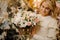 Cute bouquet of different cream flowers in wicker basket in hands of smiling woman