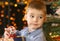 Cute boy with balloon with Santa in his hand.