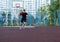 Cute boy in blue t shirt plays basketball on city playground. Active teen enjoying outdoor game with orange ball. Hobby