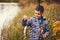 Cute boy catches fish on a summer lake