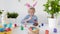 Cute boy coloring eggs for Easter holiday. Preparing for the holiday is a joy for kids. Child celebrate Easter at home or in