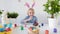 Cute boy coloring eggs for Easter holiday. Preparing for the holiday is a joy for kids. Glad child celebrate Easter at home or in