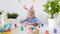 Cute boy coloring eggs for Easter holiday. Preparing for the holiday is a joy for kids. Glad child celebrate Easter at home or in