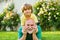 Cute boy with dad playing outdoor. Happy family Grandson hugs his grandpa on holiday. Happy grandfather and grandson