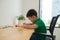 Cute boy doing homework, coloring pages, writing and painting. Children paint. Kids draw. Preschooler with books at home.