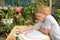 Cute boy draws rainbow. Open air. Garden in the background. Creative concept