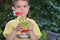 Cute boy drinking healthy cocktail fruits juice smoothie in summer. Happy child enjoying organic drink.