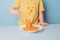 Cute boy eating spaghetti bolognese at home. concept of dirty stains on clothes. isolated on blue background