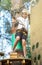 Cute boy enjoying activity in climbing adventure park at sunny summer day. Kid climbing in rope playground structure.