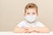 Cute boy of four years in a medical mask. Quarantined children due to an epidemic
