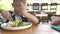 Cute boy and girl eating food in kids restaurant. Little girl and boy dinning in restaurant. Brother and sister eating