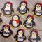 Cute boy and girl personalized Christmas penguins as decorated sugar cookies with generic names written in frosting