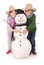 Cute boy and girl with snowman with scarf and hat