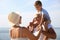 Cute boy with grandparents spending time together near sea