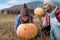 Cute boy in hat with father and Halloween Carved Pumpkin on the