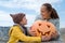 Cute boy in hat with mother and Halloween Carved Pumpkin on the