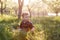 A cute boy having fun outside in the country in summer at the sunset. a boy playing with yellow dandelions in the garden