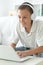 Cute boy in headphones using laptop in room