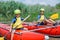 Cute boy in helmet and live vest with paddle ready for rafting on the catamaran