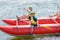 Cute boy in helmet and with paddle ready for rafting on the catamaran