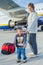 Cute boy and his grandmother prepared to fly