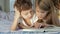 Cute boy and his sister at home reading book