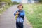 Cute boy, holding a dinosaur