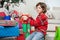 Cute Boy Kneeling By Christmas Gifts