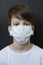 Cute boy in a medical mask. Quarantined children due to an epidemic.