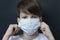 Cute boy in a medical mask. Quarantined children due to an epidemic.