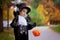 Cute boy in the park, wearing magician costume for Halloween