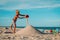 Cute boy play with sand at sea, kid building castle on tropical beach