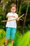 Cute boy playing with bow and arrows