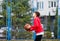 Cute boy in red t shirt plays basketball on city playground. Active teen enjoying outdoor game with orange ball. Hobby