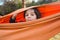 Cute boy is sitting in a hammock