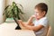 Cute boy sittingwith tablet at desk. Child using gadgets for study and play.